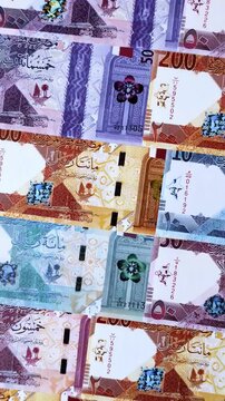 Qatar paper money, the Qatari riyal as a tool for financial transactions and trade. Qatari money as a business background for your design