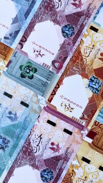 Qatar paper money, the Qatari riyal as a tool for financial transactions and trade. Qatari money as a business background for your design