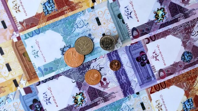 Qatar paper money, the Qatari riyal as a tool for financial transactions and trade. Qatari money as a business background for your design