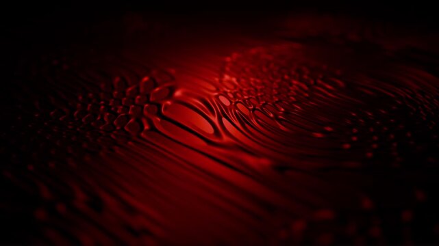Dark fluid patterns background with bloody red surface and morphing liquid organic structures. Abstract biomorphic design animation in horror style with smooth flow effect. 3D motion graphics 4K 60fps