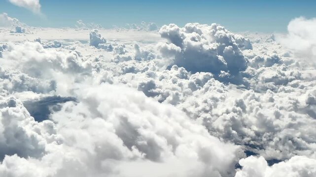 A video of an overwhelming sea of clouds taken from the left window of an airplane. The contrast between the fluffy, three-dimensional white clouds and the clear blue sky is beautiful. 1 min.