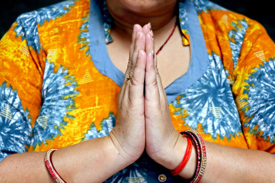 Woman Showing Namaste Gesture with Folded Hands in Traditional Indian Style