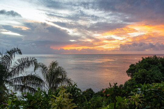 Sunset over the coastline of Huahine, French Polynesia, with lush vegetation