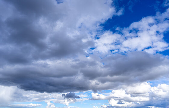 Dark storm clouds with patches of blue sky visible