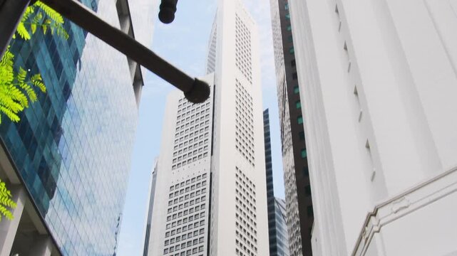 Singapore city, Singapore - march 15th, 2024: Bank of China and OCBC Centre skyscrapers in Singapore CBD. Worms eye view of modern financial district architecture at Raffles Place under a bright sky.