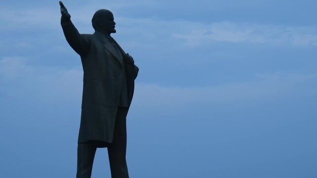 Statue of Vladimir Lenin in the central square of Osh, Kyrgyzstan. Soviet monument silhouette against a blue sky. One of the largest Lenin statues in Central Asia