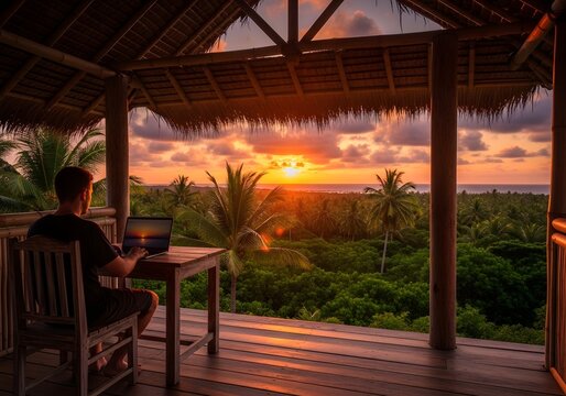 Remote worker embracing a breathtaking tropical sunset while engrossed in work on their laptop, finding inspiration and tranquility amidst lush palm trees and ocean vistas from a scenic wooden