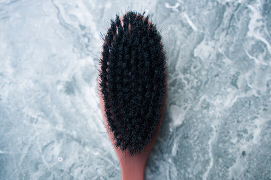 Wooden shoe brush with black bristles