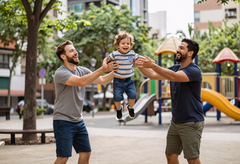 Obraz premium Happy gay parents playing with toddler in park