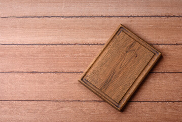 Fototapeta premium Empty wooden cutting board for preparing ingredients for home cooking. An empty cutting board