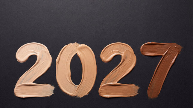 2027 painted with beige foundation cream plus darker cosmetic swatch on black surface makeup shade trend beauty product launch skincare fashion concept commercial beauty branding layout