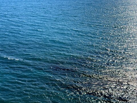 Blue ocean glittering water background.