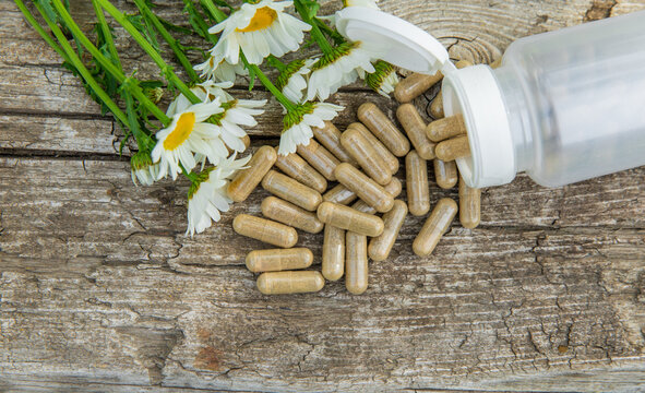 Chamomile essential oil and supplements. Selective focus.