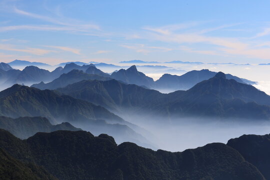 Sea of Clouds Drifting Between Mountain Ridges at Dawn