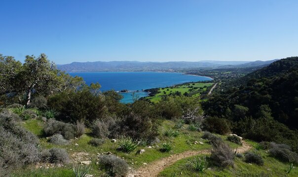 Hiking through the mountains and enjoying a scenic panorama view of the Mediterranean Ocean on the Aphrodite Trail on the Akamas peninsula in Cyprus on a sunny summer day