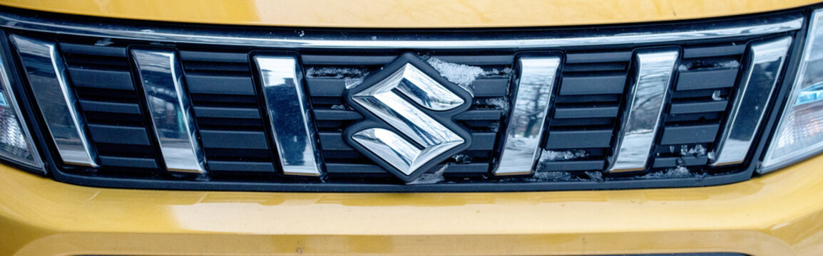 Close-up of Suzuki car front grille in winter