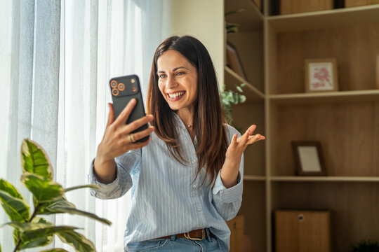 Woman smiling and waving during video call