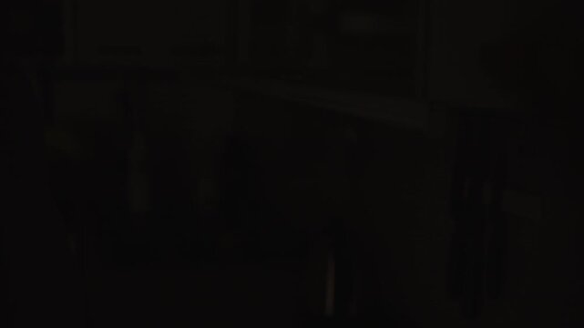 Unrecognizable person hand turning on and off contemporary led strip lamp illuminating dark kitchen. Concept of energy saving lighting, modern home interior design concepts. Shooting in slow motion.