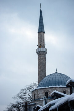 Historic mosque minaret and dome in winter snow