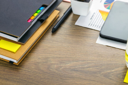 Office desk background with charts and notebooks