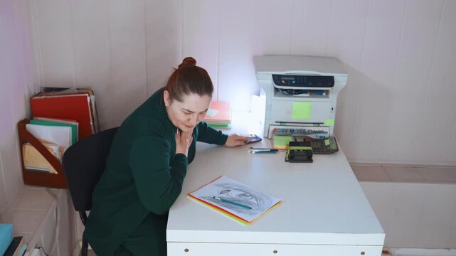 Teacher calls emergency. School staff member urgently reaches emergency services due to illness. Educator at workspace swiftly communicates with emergency responders because of sudden chest pain