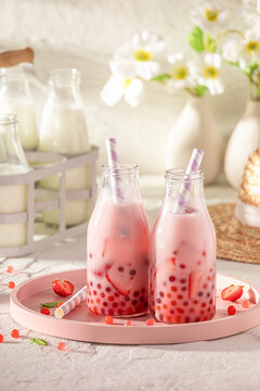 Fresh and cold strawberry bubble tea with milkshake and balls.
