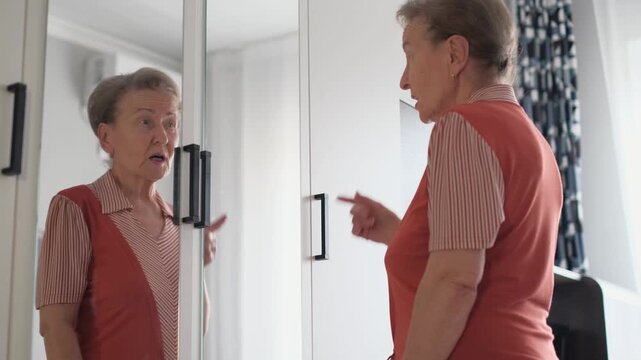 A contented old woman talks to herself while looking in the mirror