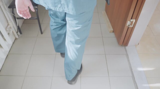 Tiled hallway paramedic hurrying with radio, black paramedic in blue scrubs moving briskly past bench, rapid footsteps on tile floor, focused stride and dispatch urgency during oncall response