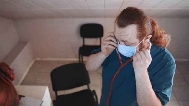Paramedic assesses patient with stethoscope. Navy scrubs paramedic conducts lung examination. Home health professional in navy attire performs auscultation to monitor lung function carefully