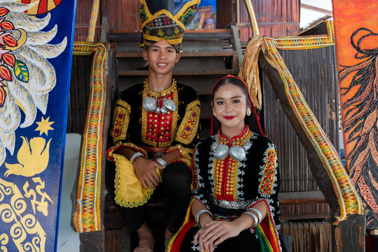 Young man and girl smiling with complete set of Dusun Tindal Clothes Sinipak during Kaamatan Harvest Festival in Sabah