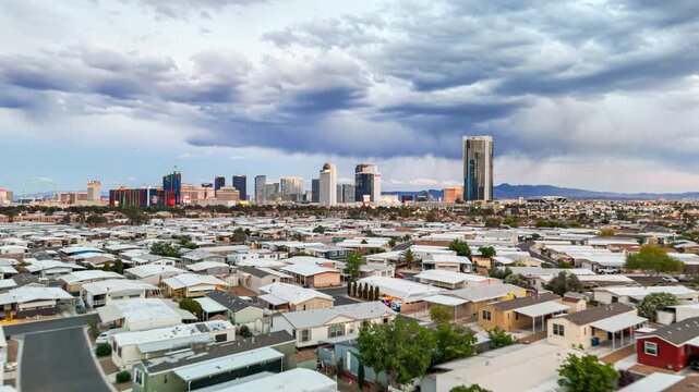 Aerial drone view over a mobile home park neighborhood in Las Vegas with the city strip skyline on the horizon