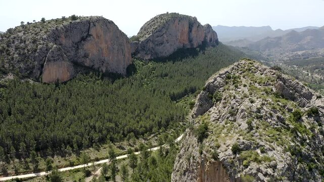 Aerial view of Sella mountains with its spectacular granite cliffs and Mediterranean pine forests, Spain. 