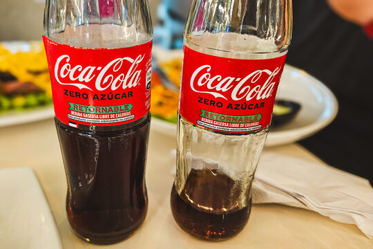 Puerto Ayora, Ecuador - May 21, 2026: Bottles of Coca-Cola Zero Sugar featuring Spanish text on the label, sitting on a table. Editorial Use Only.
