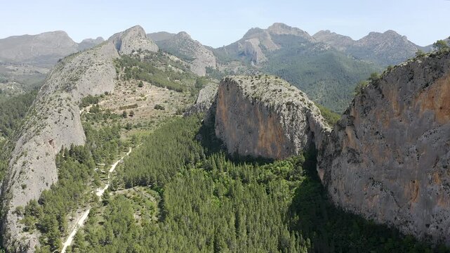 Aerial view of Sella mountains with its spectacular granite cliffs and Mediterranean pine forests, Spain. 