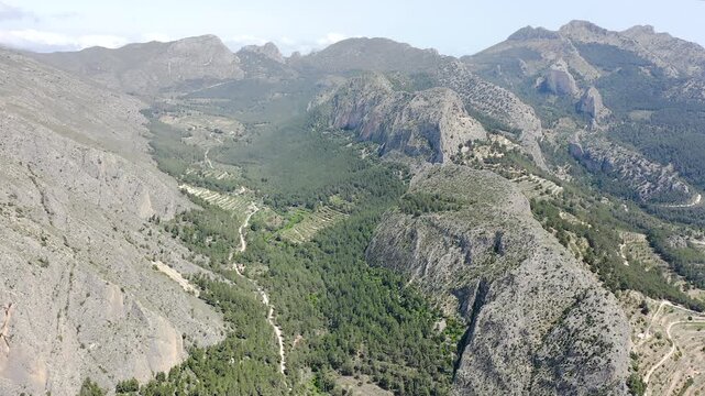 Aerial view of Sella mountains with its spectacular granite cliffs and Mediterranean pine forests, Spain. 