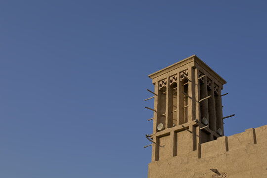 Traditional Arabian Wind Tower Architecture Against Clear Blue Sky Historic Mud Brick Barjeel Cooling Tower in Dubai