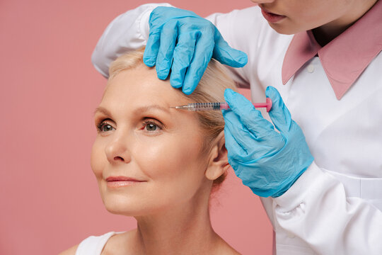 Mature woman receiving botox treatment on her forehead