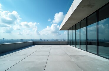 Obraz premium Empty rooftop terrace with concrete floor beside modern glass building overlooking city skyline. Bright blue sky with clouds above urban cityscape.