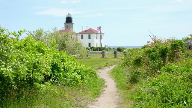 path leading to historic Beavertail Lighthouse on sunny summer day