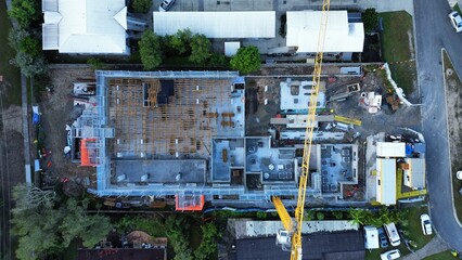Top Down Aerial View of Active Urban Construction Site and Tower Crane Development © GoAerials