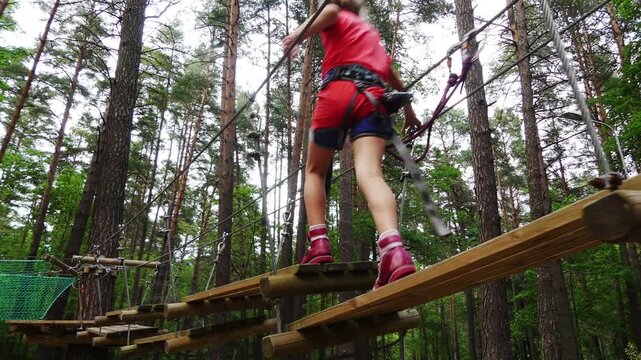 Small girl with helmet in adventure park