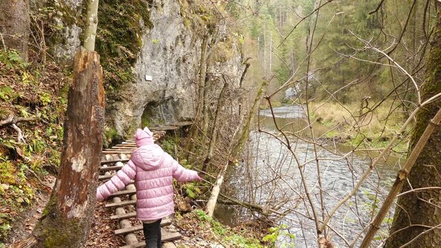Little beautiful girl walks in Slovak Paradise. Slovak Paradise (Slovensky raj) is mountain range in eastern Slovakia, part of Spis-Gemer Karst, located between towns of Spisska Nova Ves and Dobsina.