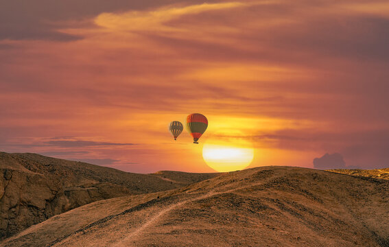 Hot air billon over mountain in sunrise