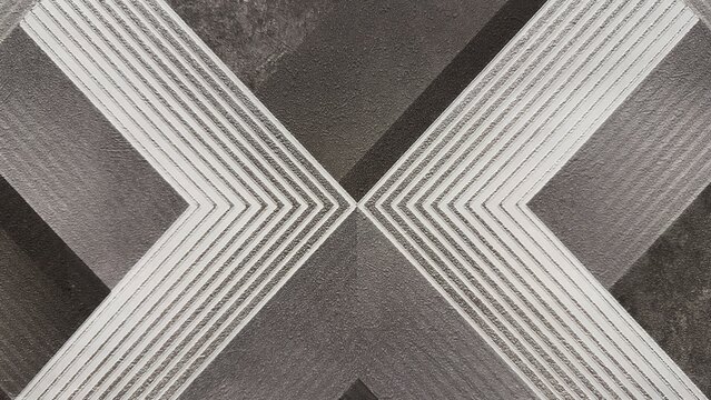 Abstract geometric texture background with white X shape lines on dark grey concrete wall, modern wallpaper pattern