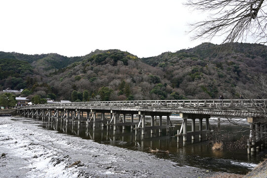 Togetsu-kyo Bridge in January, Kyoto, Japan. A somber mid-winter landscape in Arashiyama reflecting the stillness and wabi-sabi aesthetic.