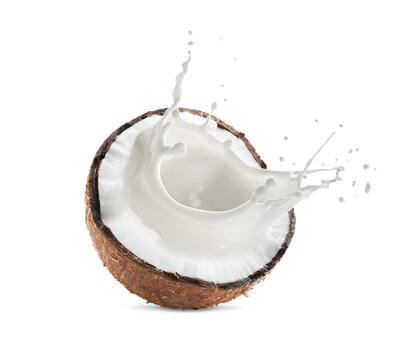 Coconut milk splashing out of nut isolated on white