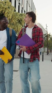Diverse group of university students walking together outside campus