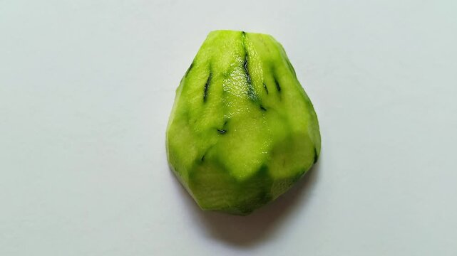 Peeled whole chayote Sechium edule squash isolated on white background
