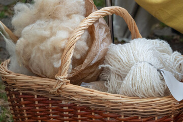 Wool and yarn in a basket at a fair © Iryna