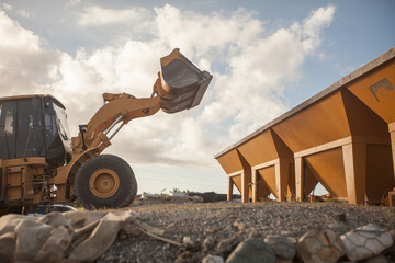 Fototapeta premium Heavy wheel loader machine working at an industrial construction or mining site